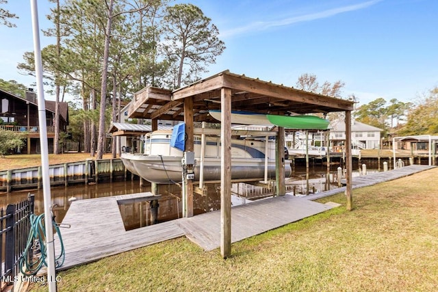 dock area featuring a lawn and a water view