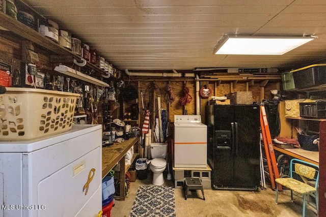 interior space with a workshop area, black fridge with ice dispenser, and washer / clothes dryer