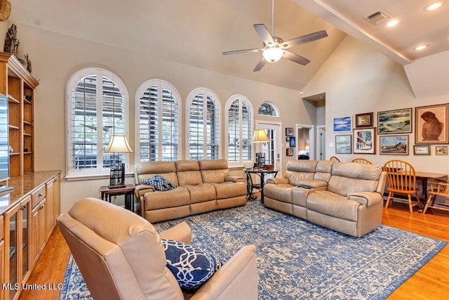 living room with lofted ceiling, ceiling fan, and hardwood / wood-style floors