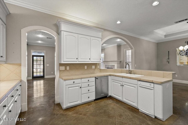 kitchen with tile countertops, visible vents, arched walkways, and stainless steel dishwasher