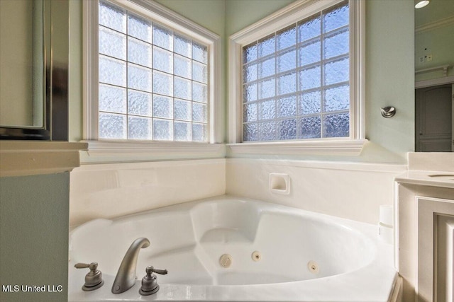 full bath featuring a whirlpool tub and a wealth of natural light