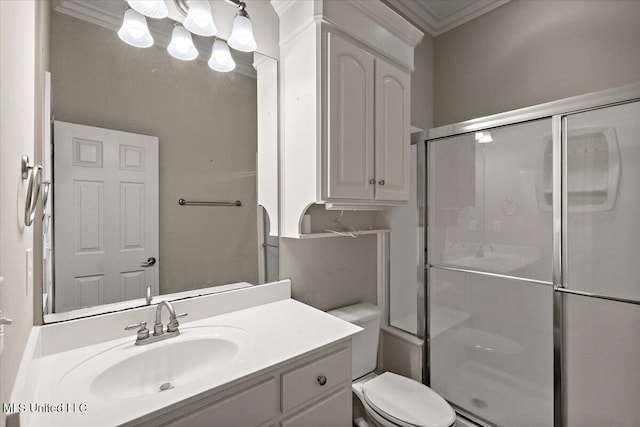 full bathroom featuring a stall shower, crown molding, vanity, and toilet