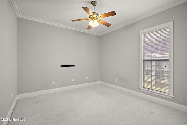 spare room featuring carpet floors, baseboards, ornamental molding, and ceiling fan