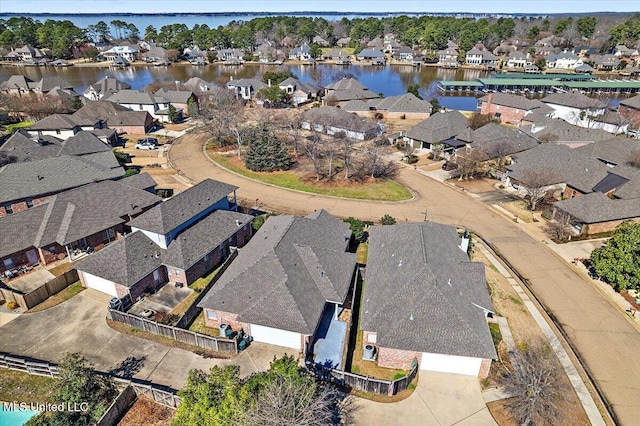 drone / aerial view featuring a water view and a residential view