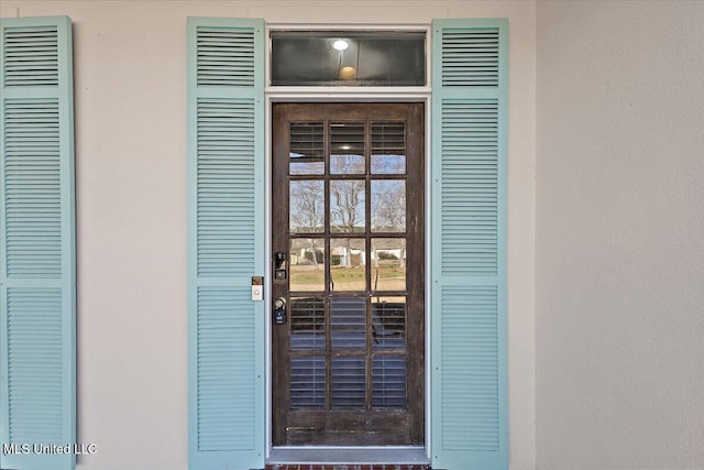 view of exterior entry featuring stucco siding