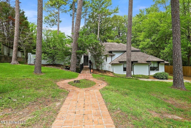 4441 Wedgewood St, Jackson, MS 39211 - view of front of home with a shingled roof, brick siding, fence, and a front yard