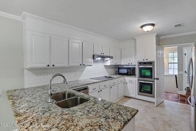 kitchen with kitchen peninsula, white cabinets, backsplash, black appliances, and sink