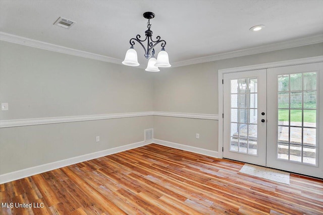 interior space featuring french doors, light hardwood / wood-style floors, and an inviting chandelier