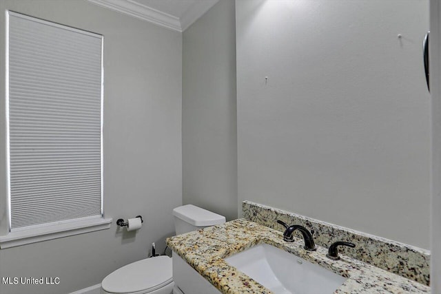 bathroom featuring vanity, toilet, and crown molding