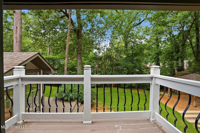 wooden deck featuring a yard