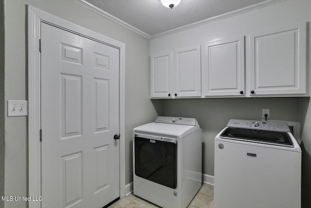 clothes washing area featuring light tile patterned floors, separate washer and dryer, a textured ceiling, crown molding, and cabinets