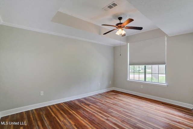 empty room with crown molding, wood-type flooring, and ceiling fan