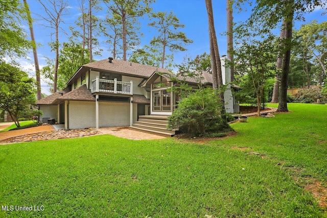 rear view of property with a lawn