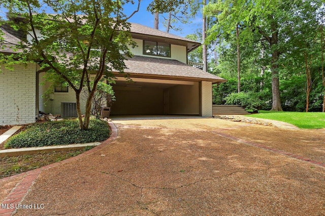 4441 Wedgewood St, Jackson, MS 39211 - view of front facade featuring concrete driveway, brick siding, roof with shingles, and a carport