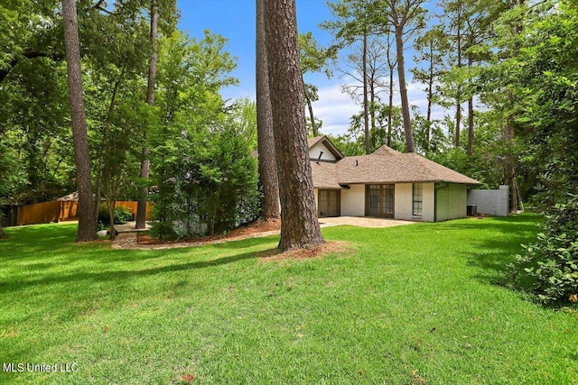 4441 Wedgewood St, Jackson, MS 39211 - back of property featuring a lawn, a patio area, and french doors