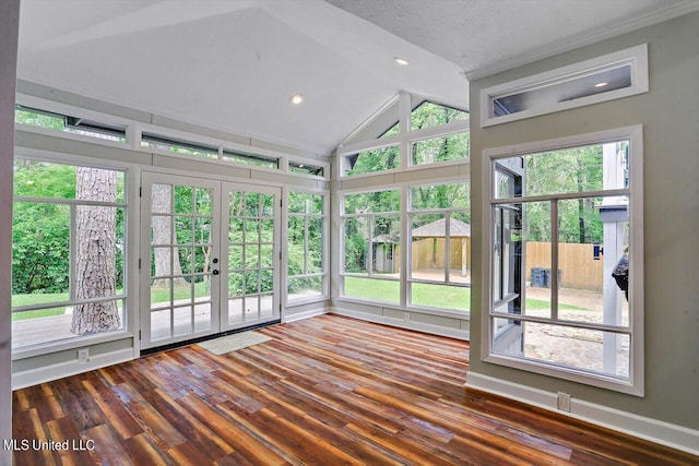 unfurnished sunroom featuring a wealth of natural light, lofted ceiling, and french doors