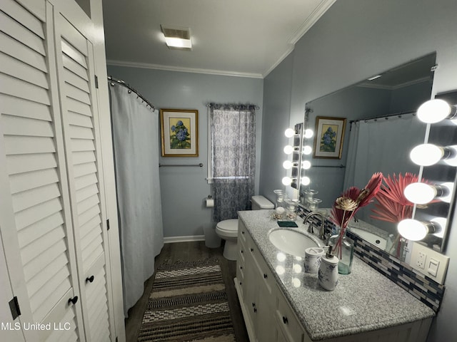 bathroom with vanity, hardwood / wood-style floors, crown molding, and toilet