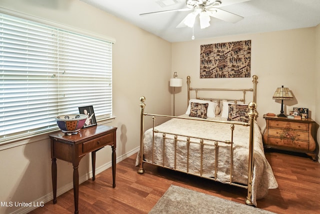 bedroom with ceiling fan and dark hardwood / wood-style flooring