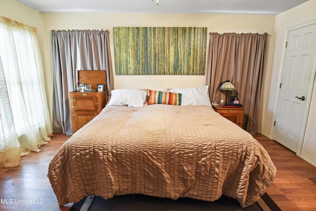 bedroom featuring hardwood / wood-style flooring and multiple windows