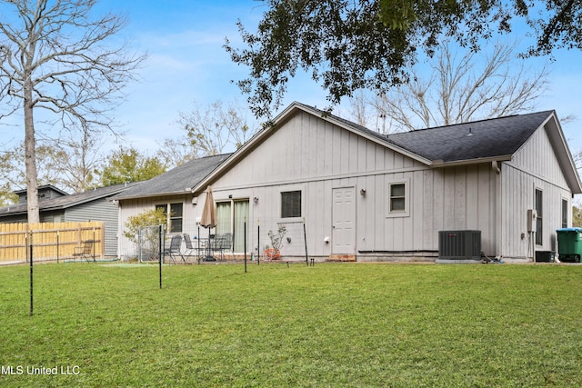 rear view of house featuring a yard and cooling unit