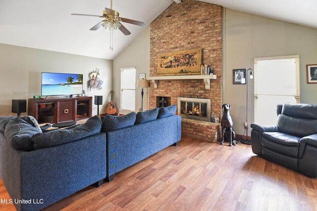 living room with hardwood / wood-style floors, ceiling fan, a fireplace, and a wealth of natural light