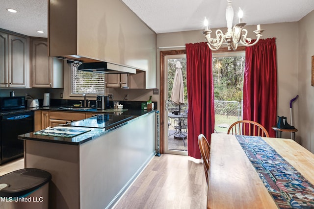 kitchen with an inviting chandelier, black appliances, sink, light hardwood / wood-style flooring, and a textured ceiling