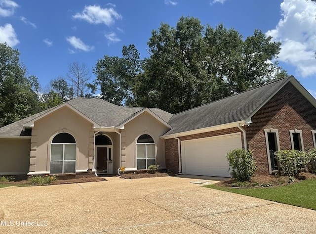 149 Cross Creek Dr, Madison, MS 39110 - single story home featuring a garage, concrete driveway, a shingled roof, stucco siding, and brick siding