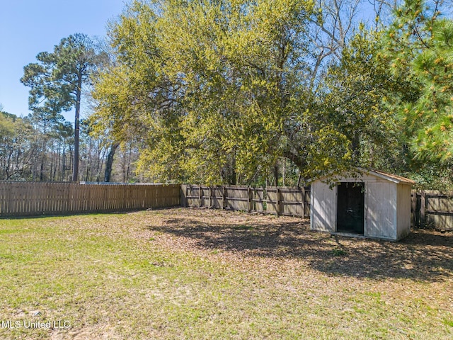 view of yard featuring an outbuilding, a storage unit, and a fenced backyard