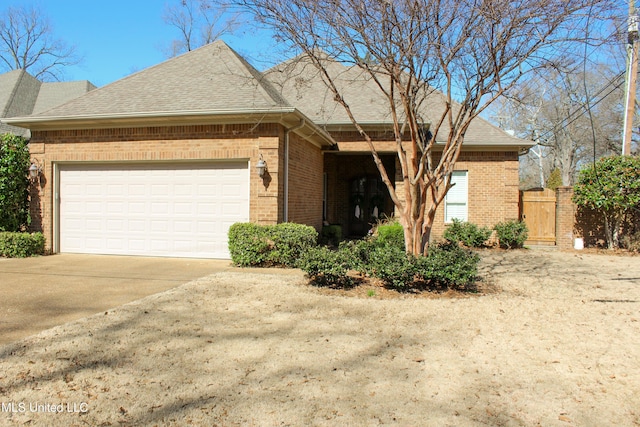 view of front of property featuring concrete driveway, brick siding, an attached garage, and a shingled roof