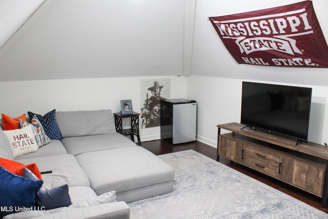 living room with lofted ceiling, dark wood finished floors, and baseboards