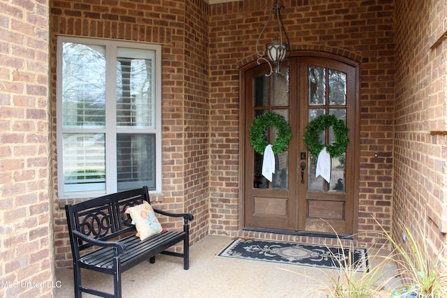 doorway to property with french doors and brick siding