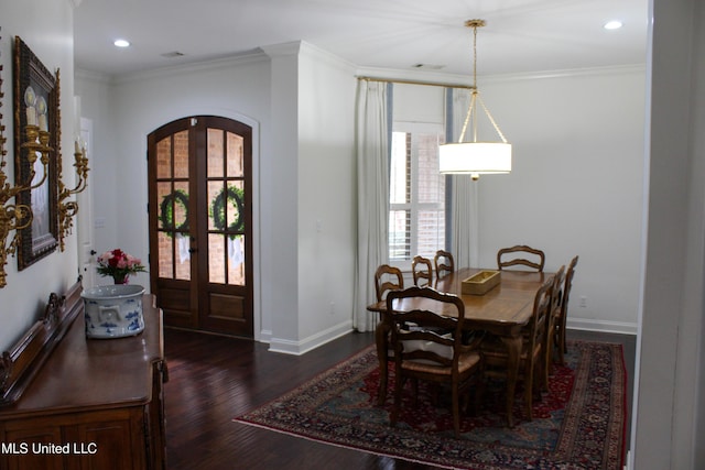 dining space with arched walkways, french doors, dark wood-style flooring, crown molding, and baseboards