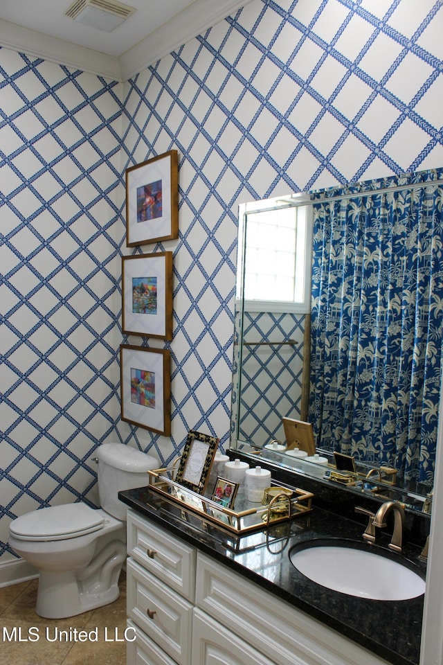 bathroom with tile walls, visible vents, toilet, vanity, and tile patterned floors