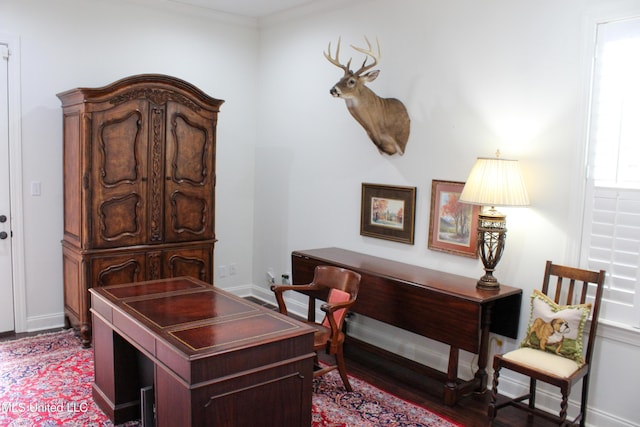 home office featuring ornamental molding, wood finished floors, and baseboards