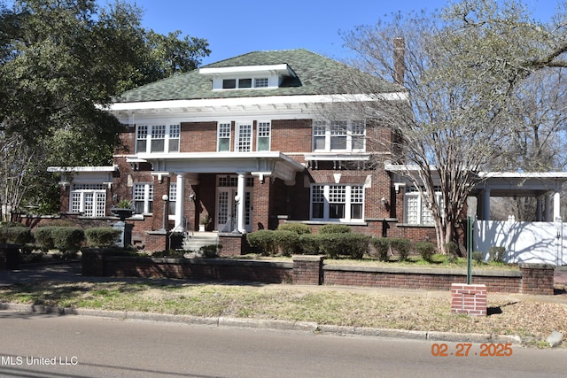 traditional style home with brick siding