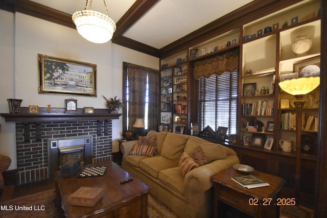 living room featuring ornamental molding and a tiled fireplace