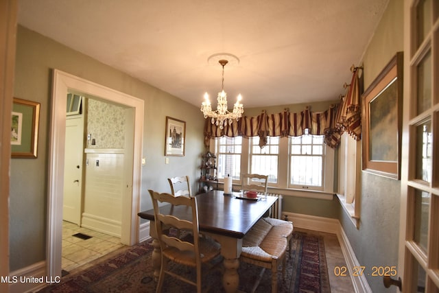 tiled dining room featuring visible vents, baseboards, and an inviting chandelier