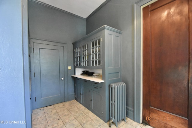 bar featuring radiator heating unit and light tile patterned floors