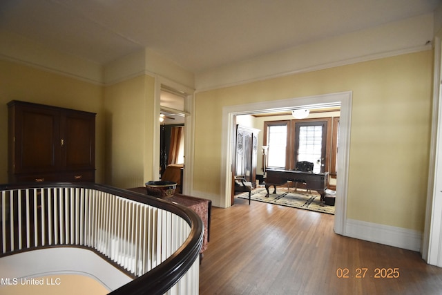 foyer featuring baseboards and wood finished floors