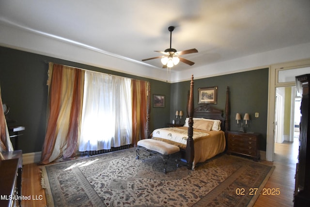 bedroom featuring baseboards and wood finished floors