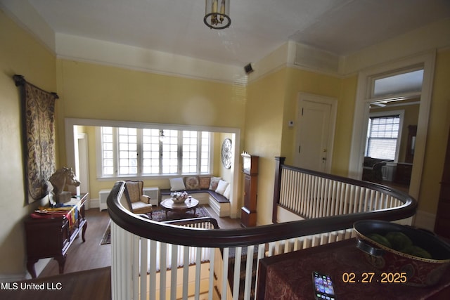 living area with wood finished floors, visible vents, and a healthy amount of sunlight