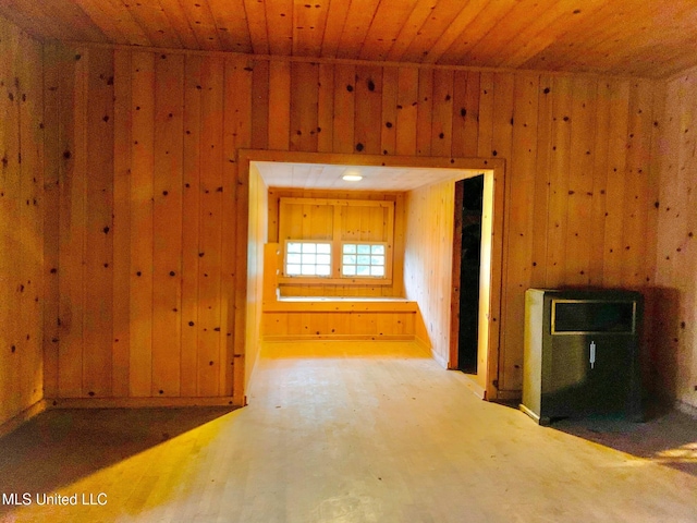 interior space featuring wooden ceiling and wooden walls