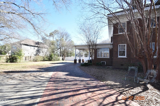 view of road with decorative driveway