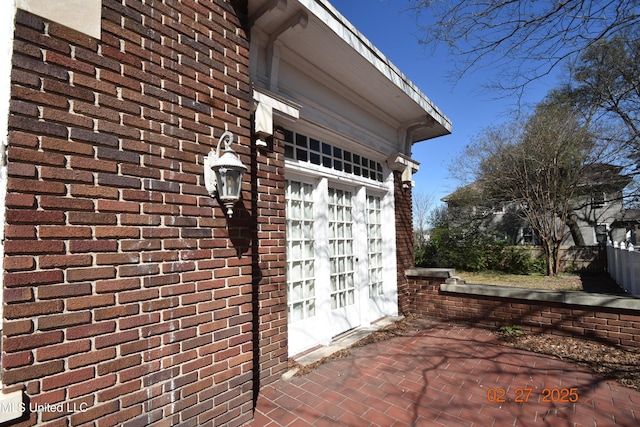 exterior details featuring brick siding