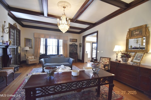 living room featuring an inviting chandelier, coffered ceiling, wood finished floors, and beamed ceiling