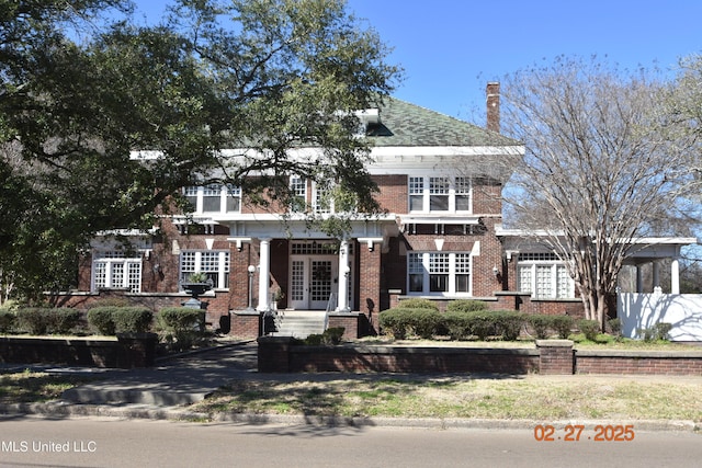 view of front of house featuring french doors and brick siding