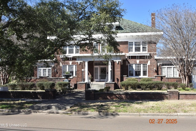 view of front of house featuring french doors and brick siding