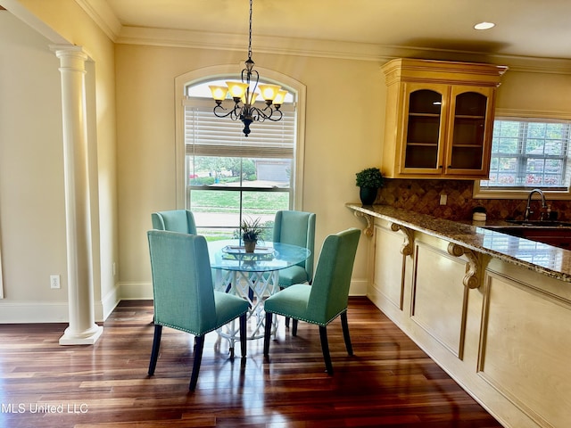 104 Faith Way, Brandon, MS 39042 - dining room featuring decorative columns, a chandelier, baseboards, dark wood-type flooring, and ornamental molding