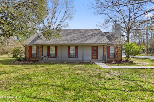 7300 Frank Snell Rd, Moss Point, MS 39562 - view of front facade with a porch, a chimney, a front lawn, and brick siding