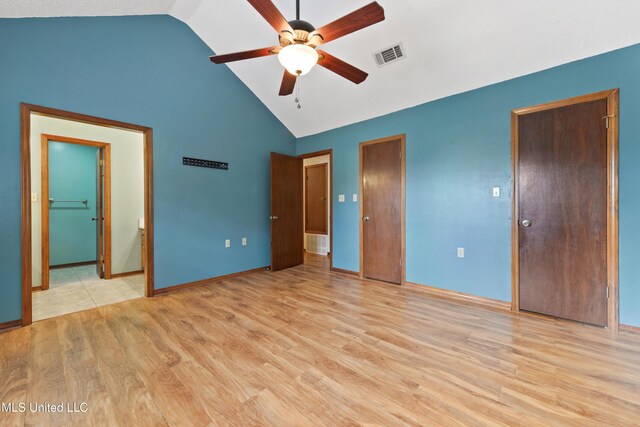 7300 Frank Snell Rd, Moss Point, MS 39562 - unfurnished bedroom with light wood-style flooring, baseboards, high vaulted ceiling, multiple closets, and a ceiling fan
